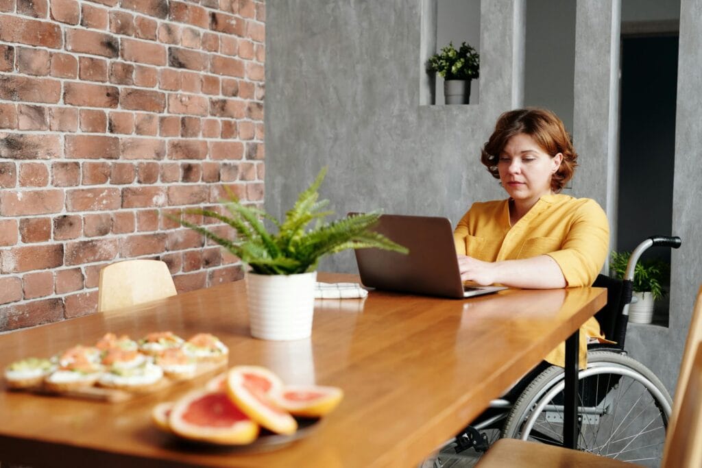 NDIS Cleaning Woman in wheelchair working at while Blue Clean takes care of the cleaning